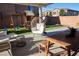 This backyard boasts a covered patio, seating, artificial lawn, and playground at 7468 Wellfleet Bay Ave, Las Vegas, NV 89179
