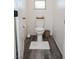 Small powder room has wood look floors and white toilet at 7468 Wellfleet Bay Ave, Las Vegas, NV 89179