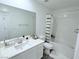Bright bathroom with a large mirror, sleek vanity, and a shower-tub combination with a stylish curtain at 7468 Wellfleet Bay Ave, Las Vegas, NV 89179