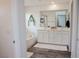 Bright bathroom features a double vanity and white cabinets at 7468 Wellfleet Bay Ave, Las Vegas, NV 89179