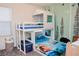 bedroom with a unique bunk bed design, whimsical wall decor, and ample storage at 7468 Wellfleet Bay Ave, Las Vegas, NV 89179