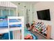 bedroom featuring a bunk bed, whimsical wall decor, and convenient toy storage at 7468 Wellfleet Bay Ave, Las Vegas, NV 89179