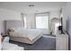 Bedroom with a neutral palette, gray carpet and large mirror at 7468 Wellfleet Bay Ave, Las Vegas, NV 89179