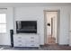 Bedroom with a dresser with a television and entrance to the bathroom at 7468 Wellfleet Bay Ave, Las Vegas, NV 89179