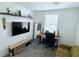 Bedroom featuring a modern desk, large screen TV, and a decorative floating shelf at 7468 Wellfleet Bay Ave, Las Vegas, NV 89179