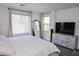 Bright bedroom with large windows, dresser, and plush carpet offers a comfortable and stylish retreat at 7468 Wellfleet Bay Ave, Las Vegas, NV 89179