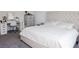 Bedroom with a tufted headboard bed, a vanity with a lighted mirror, and a dresser at 7468 Wellfleet Bay Ave, Las Vegas, NV 89179