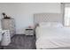 Bright bedroom features a tufted headboard, neutral palette, and gray carpet at 7468 Wellfleet Bay Ave, Las Vegas, NV 89179