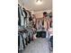 Spacious walk-in closet with ample storage and shelving, and gray carpet at 7468 Wellfleet Bay Ave, Las Vegas, NV 89179