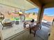 Inviting covered patio with comfortable seating, dining area, and view of the backyard play area at 7468 Wellfleet Bay Ave, Las Vegas, NV 89179