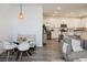 Cozy dining area adjacent to the kitchen features modern seating, and a stylish pendant light, enhancing the home's charm at 7468 Wellfleet Bay Ave, Las Vegas, NV 89179