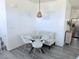 Bright dining nook featuring a glass table, modern chairs, and stylish lighting at 7468 Wellfleet Bay Ave, Las Vegas, NV 89179
