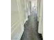 Hallway with gray carpet and white doors leading to various rooms in the house at 7468 Wellfleet Bay Ave, Las Vegas, NV 89179