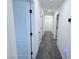A freshly painted hallway with neutral carpet leading to additional rooms at 7468 Wellfleet Bay Ave, Las Vegas, NV 89179