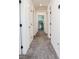 Bright hallway featuring neutral carpet and white doors leading to various rooms in the home at 7468 Wellfleet Bay Ave, Las Vegas, NV 89179