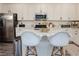 Bright kitchen featuring a large island with seating and modern appliances at 7468 Wellfleet Bay Ave, Las Vegas, NV 89179