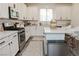 Updated kitchen with white countertops, stainless steel appliances, and center island at 7468 Wellfleet Bay Ave, Las Vegas, NV 89179