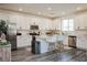 Well-lit kitchen with white cabinets, an island, and stainless steel appliances at 7468 Wellfleet Bay Ave, Las Vegas, NV 89179