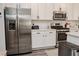Modern kitchen with stainless steel appliances and white cabinets at 7468 Wellfleet Bay Ave, Las Vegas, NV 89179