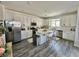 Bright kitchen featuring stainless steel appliances, an island, and wood-look flooring at 7468 Wellfleet Bay Ave, Las Vegas, NV 89179