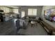Cozy living room adjacent to kitchen featuring modern furnishings and lots of light at 7468 Wellfleet Bay Ave, Las Vegas, NV 89179