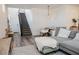 Open-concept living area with stairs, a comfortable gray sofa, and a modern dining setup, great for easy living at 7468 Wellfleet Bay Ave, Las Vegas, NV 89179