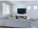 Comfortable living room featuring a large sectional and neutral decor at 7468 Wellfleet Bay Ave, Las Vegas, NV 89179