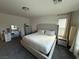A bedroom featuring a large bed, stylish furniture, and a bright window at 7468 Wellfleet Bay Ave, Las Vegas, NV 89179
