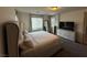 A bedroom features a large bed, neutral walls, and a window at 7468 Wellfleet Bay Ave, Las Vegas, NV 89179