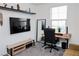 Bright home office features a sleek desk setup, comfortable seating, and stylish decor accents at 7468 Wellfleet Bay Ave, Las Vegas, NV 89179