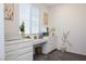 Functional home office with built-in white desk, cabinets, and decor next to a window at 7468 Wellfleet Bay Ave, Las Vegas, NV 89179