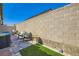 Private backyard patio featuring brick pavers and artificial turf at 7533 Garnet Moon St, North Las Vegas, NV 89084