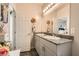 Well-lit bathroom with dual sinks, granite counters, and a decorative mirror, offering a luxurious and functional space at 7533 Garnet Moon St, North Las Vegas, NV 89084