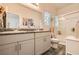 Modern bathroom with granite countertop double sinks, a shower, and toilet offering a clean and bright space at 7533 Garnet Moon St, North Las Vegas, NV 89084