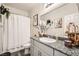 Well-lit bathroom with granite countertop, framed mirror, and decorative vases at 7533 Garnet Moon St, North Las Vegas, NV 89084