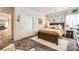 Well-lit bedroom featuring a bed, a side table, closet, and a decorative wall creating a relaxing and inviting atmosphere at 7533 Garnet Moon St, North Las Vegas, NV 89084