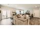 Open-concept kitchen features a granite island, stainless sink, and a seamless flow to the dining and living areas at 7533 Garnet Moon St, North Las Vegas, NV 89084