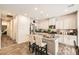 Stylish kitchen with white cabinetry, stainless steel appliances, granite countertops, and a center island with seating at 7533 Garnet Moon St, North Las Vegas, NV 89084