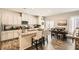 Modern kitchen with white cabinets, granite countertops, stainless steel appliances, and open dining area at 7533 Garnet Moon St, North Las Vegas, NV 89084
