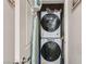 Compact laundry closet with stacked washer and dryer, maximizing space at 7533 Garnet Moon St, North Las Vegas, NV 89084