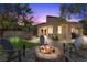 Outdoor patio with a fire pit, outdoor furniture, mature trees, and a cozy ambiance at 7627 Boca Raton Dr, Las Vegas, NV 89113