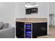 Stylish bar area with dark cabinetry, granite countertops, and a wine refrigerator at 7627 Boca Raton Dr, Las Vegas, NV 89113