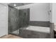 Modern bathroom featuring glass enclosed shower, soaking tub and updated fixtures at 7627 Boca Raton Dr, Las Vegas, NV 89113