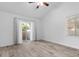 Bright bedroom with wood floors, natural light, and a sliding glass door to the outside at 7627 Boca Raton Dr, Las Vegas, NV 89113