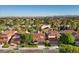 Beautiful homes with red tile roofs line a street near the Spanish Trail Country Club golf course and the mountains at 7627 Boca Raton Dr, Las Vegas, NV 89113