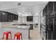 Modern kitchen features dark wood cabinetry, granite countertops, and stainless steel appliances at 7627 Boca Raton Dr, Las Vegas, NV 89113