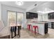 Modern kitchen with stainless steel appliances, dark cabinets, bright tile floors, and plenty of natural light at 7627 Boca Raton Dr, Las Vegas, NV 89113