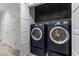 Functional laundry room with washer, dryer, and built-in storage cabinets at 7627 Boca Raton Dr, Las Vegas, NV 89113