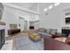 Bright living room with high ceilings, a fireplace, and an open layout to the kitchen at 7627 Boca Raton Dr, Las Vegas, NV 89113