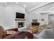 Cozy living room with a brick fireplace, comfortable seating, and modern decor at 7627 Boca Raton Dr, Las Vegas, NV 89113